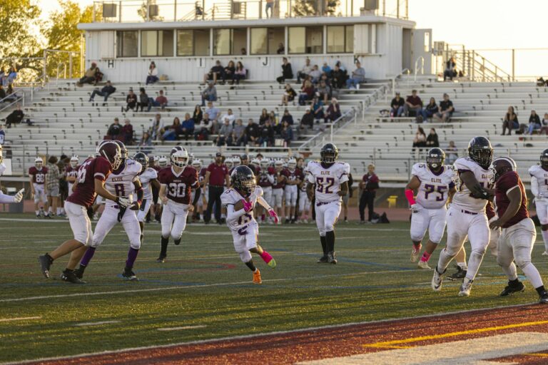 Intense American football game with players in action at a bustling stadium, showcasing team sportsmanship.