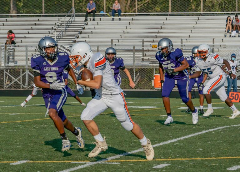 Intense high school football game in Columbia, MD with athletes in action.
